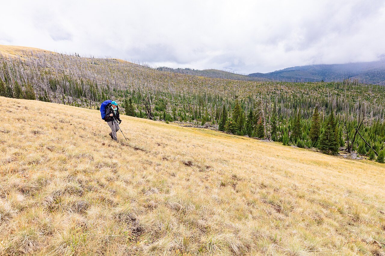 Solo backpacker hiking on a mountain trail