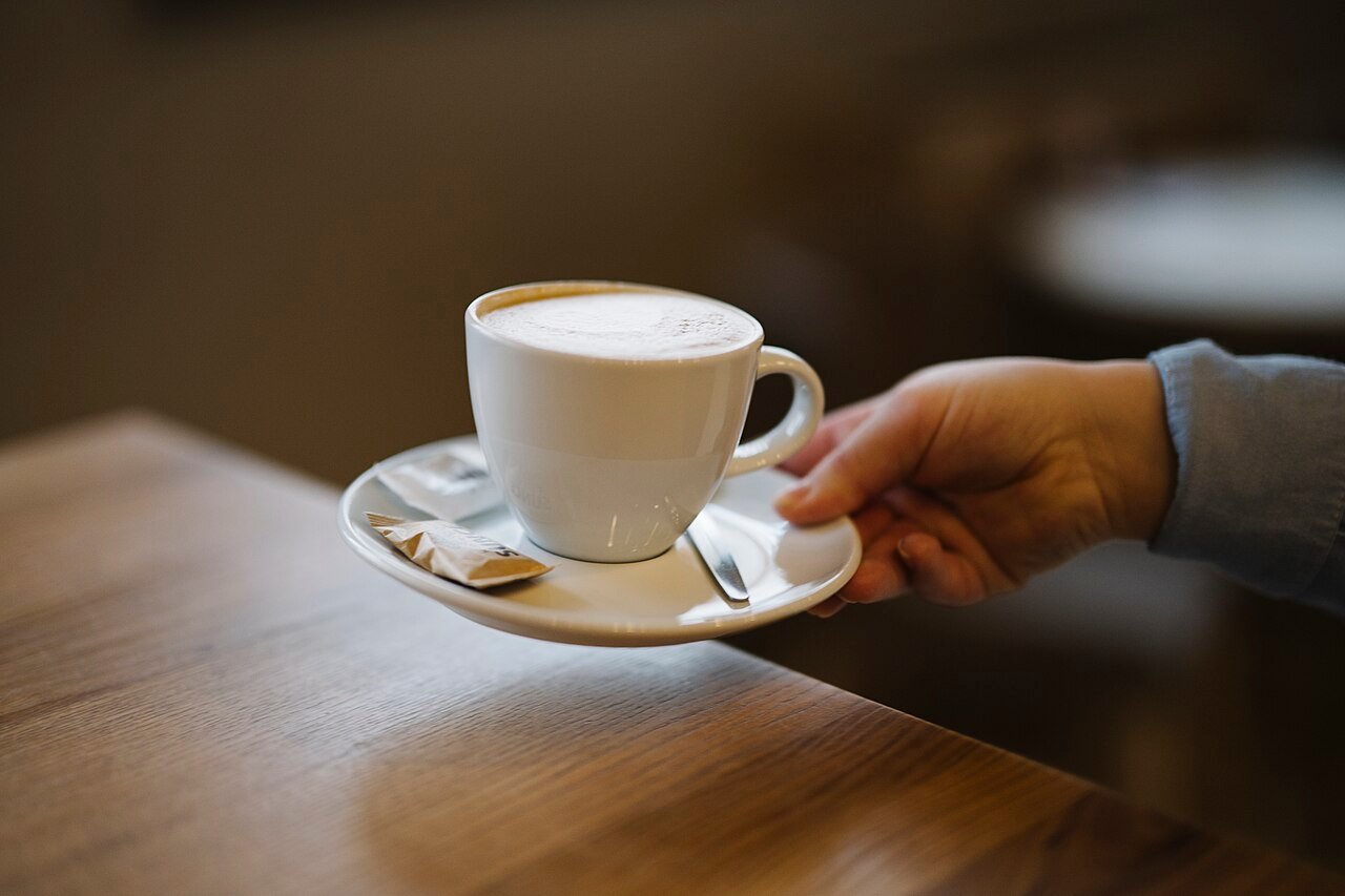 Warm cup of coffee on a table at a cafe