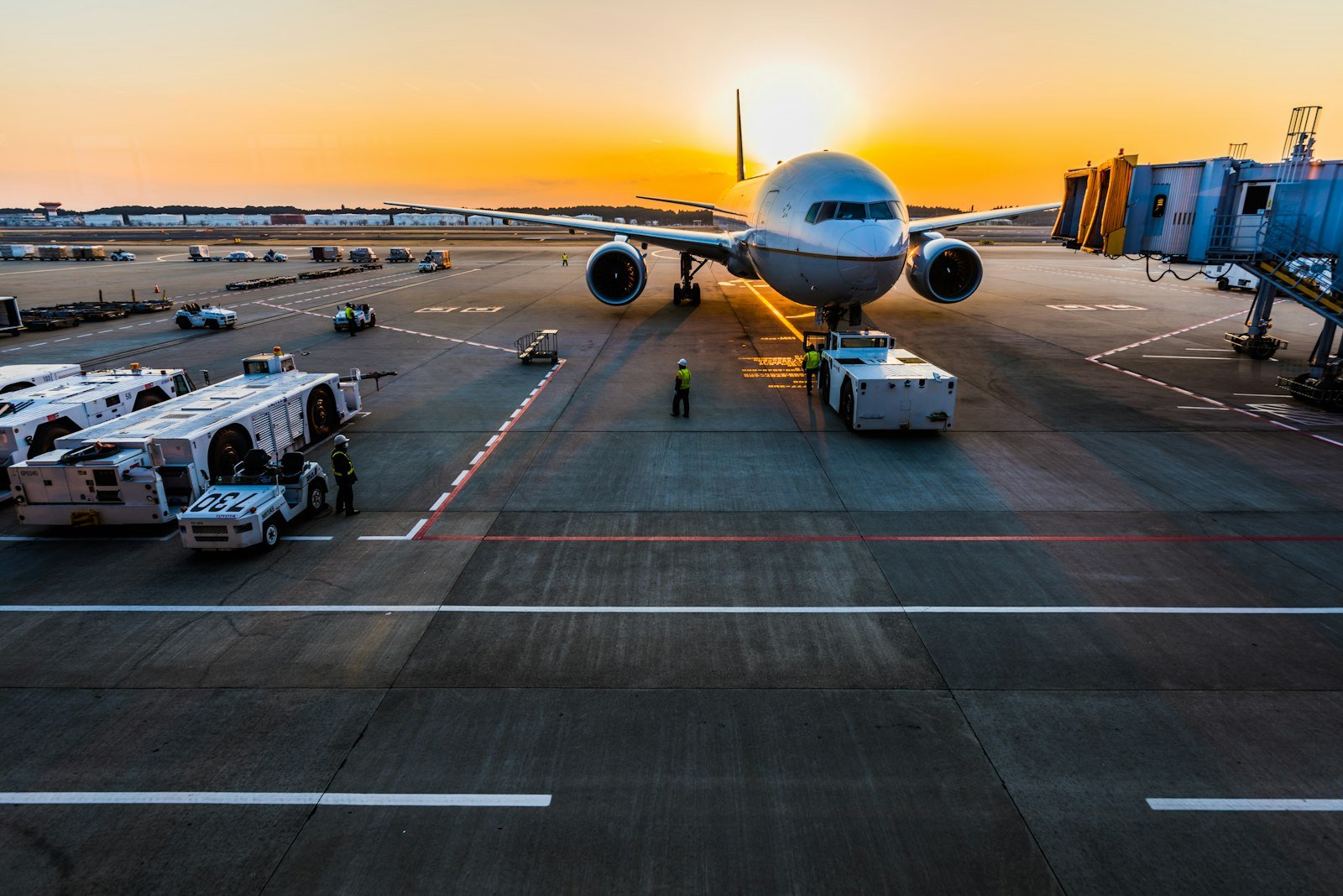 Gray airplane parked at the gate before departure