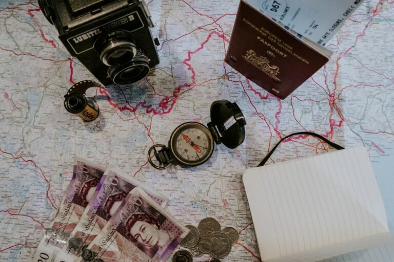 Black pocket watch beside banknotes, travel and money concept