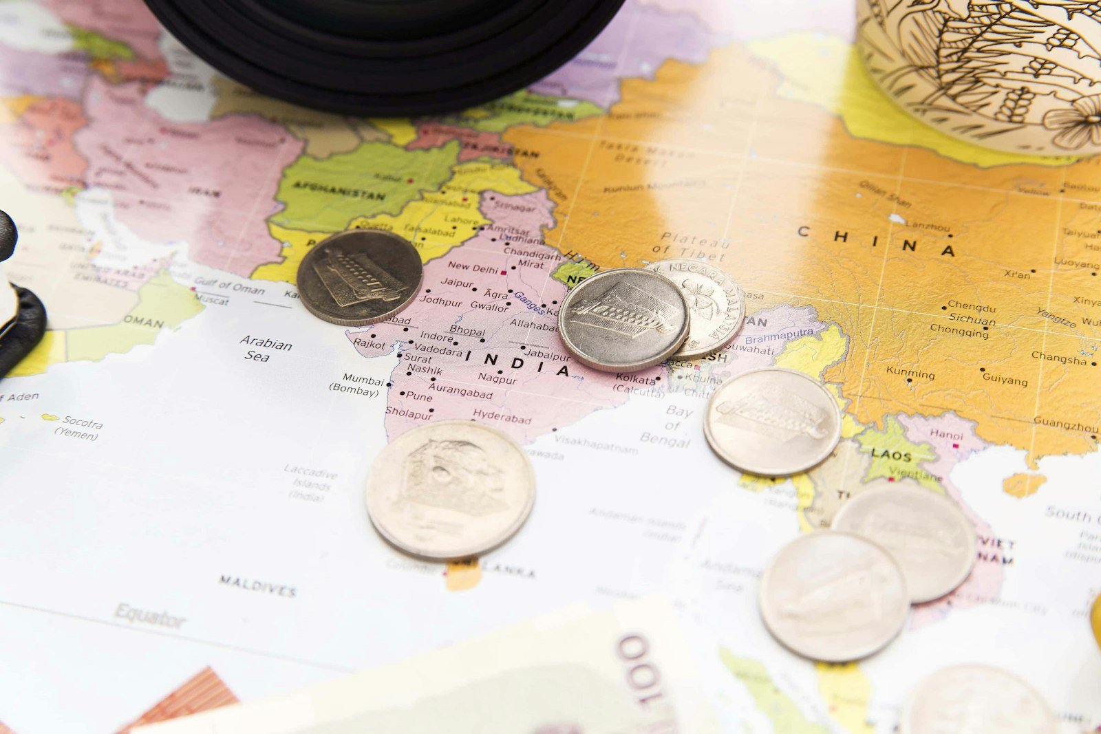 A bunch of coins sitting on top of a map